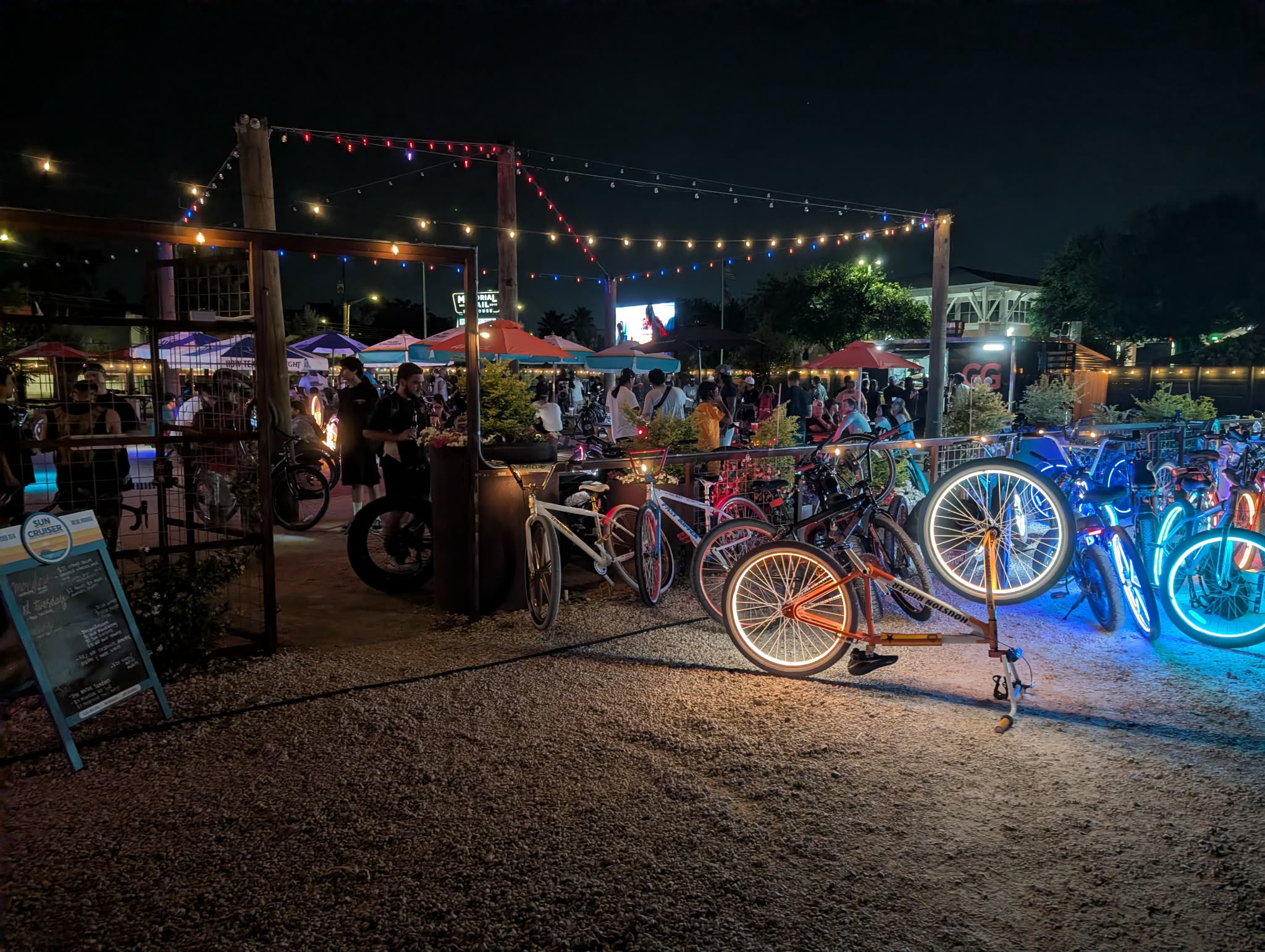 Bikes parked outside under patio string lights